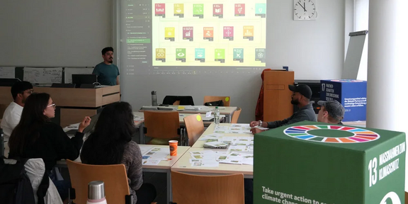 Photo of Víctor Cobs-Muñoz leading the Sustain2030 simulation game