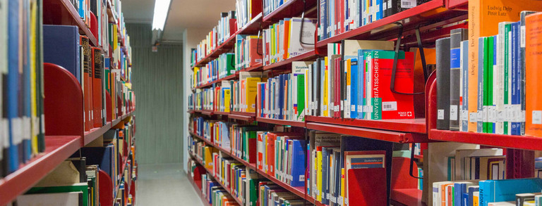 Red bookshelves in the university library.